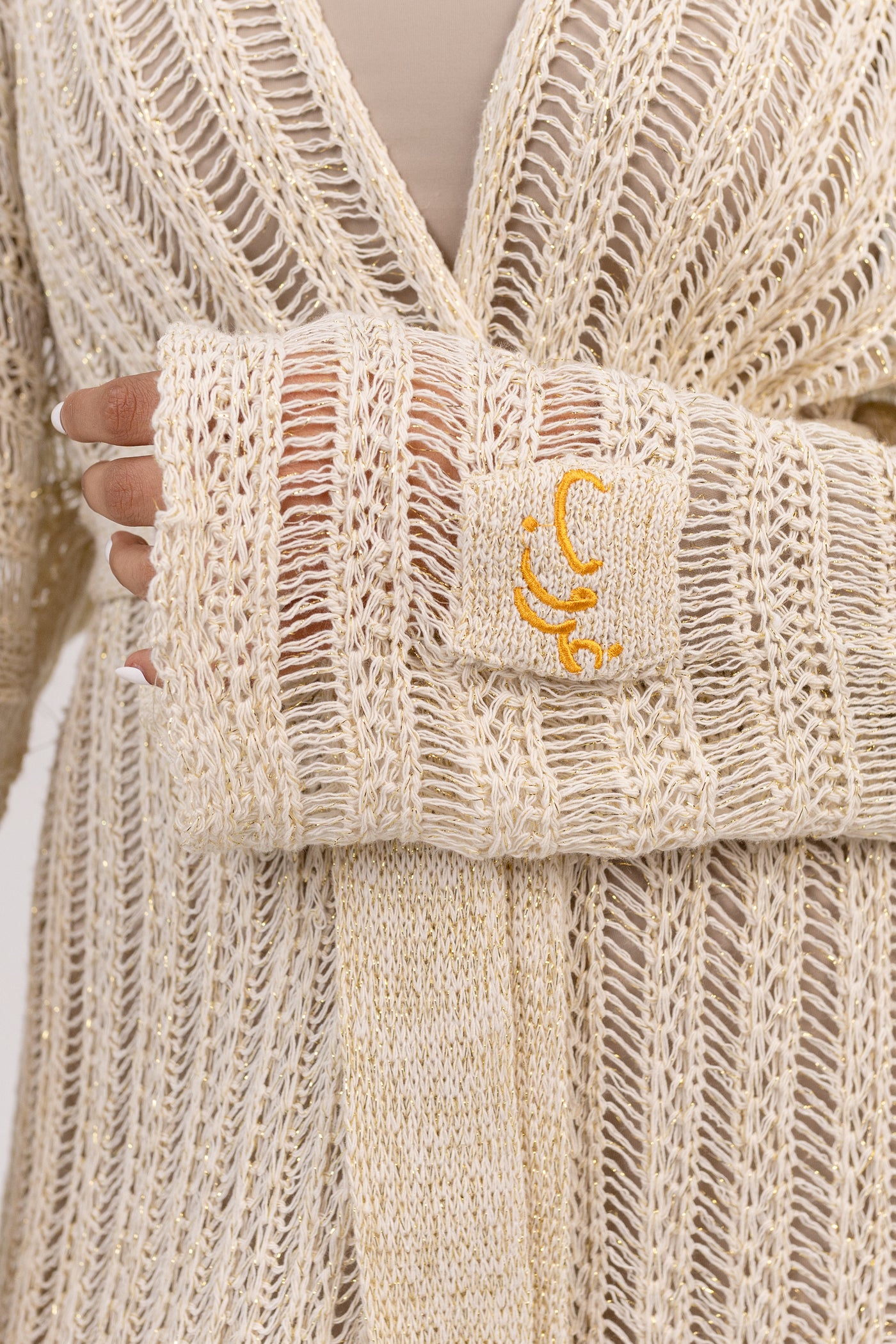 Ghoroub Cardigan in Sunset Ivory · Gold, knit and Ghoroub embroidery detail
