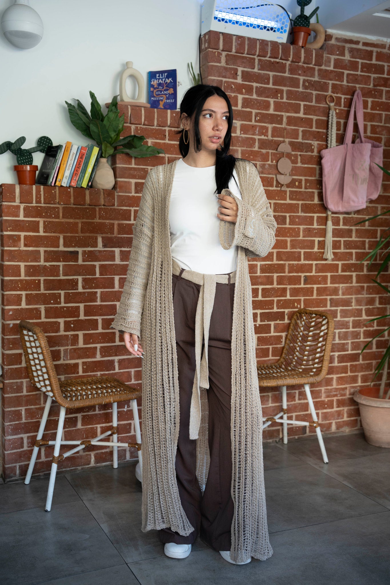 Ghoroub Cardigan in Dusk Beige · Silver, worn as an everyday layer in a café setting.