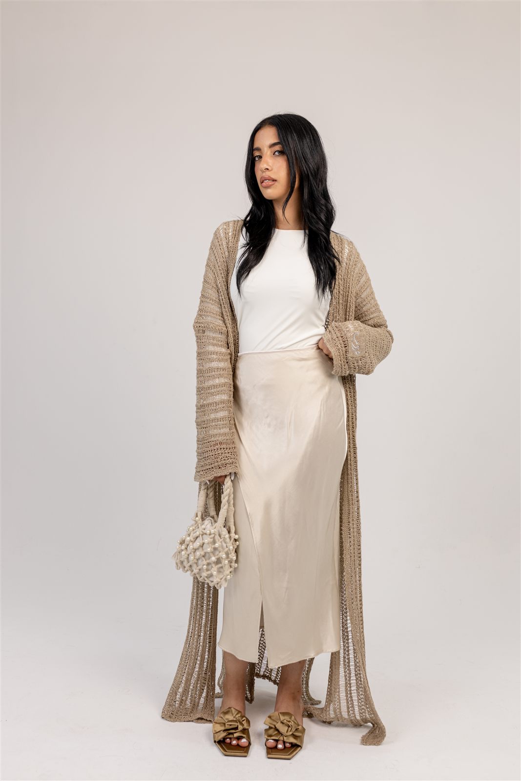 Ghoroub Cardigan layered over a dress.